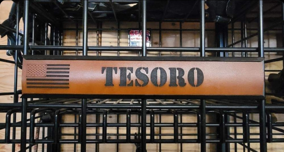 A brown, custom leather name plate with an embossed American flag and the word 'TESORO' on it, displayed on a metal locker.
